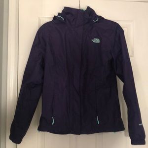 Plum North face rain jacket with teal zippers.